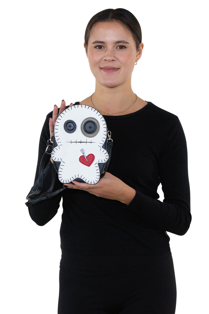 Stitched Voodoo Doll Shoulder Crossbody Bag in Vinyl Material, front view, handheld by model